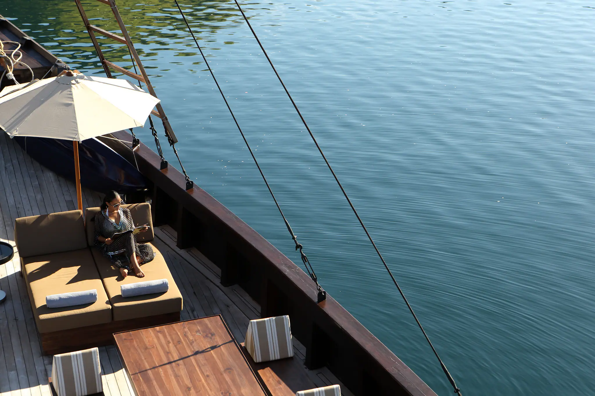 Alila Purnama Boutique Sailing Yacht | Relaxing on side deck lounge