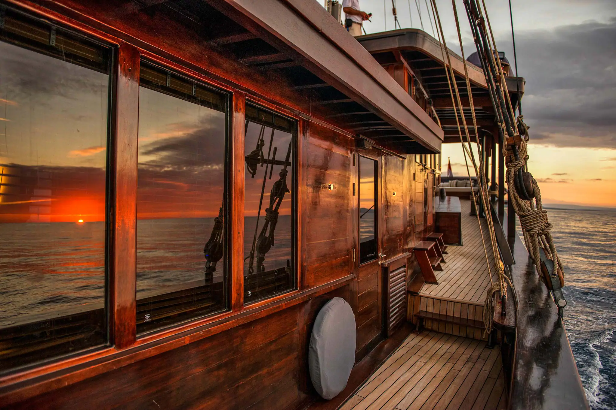 Amandira Luxury Sailing Yacht | Sunset reflections on wooden deck