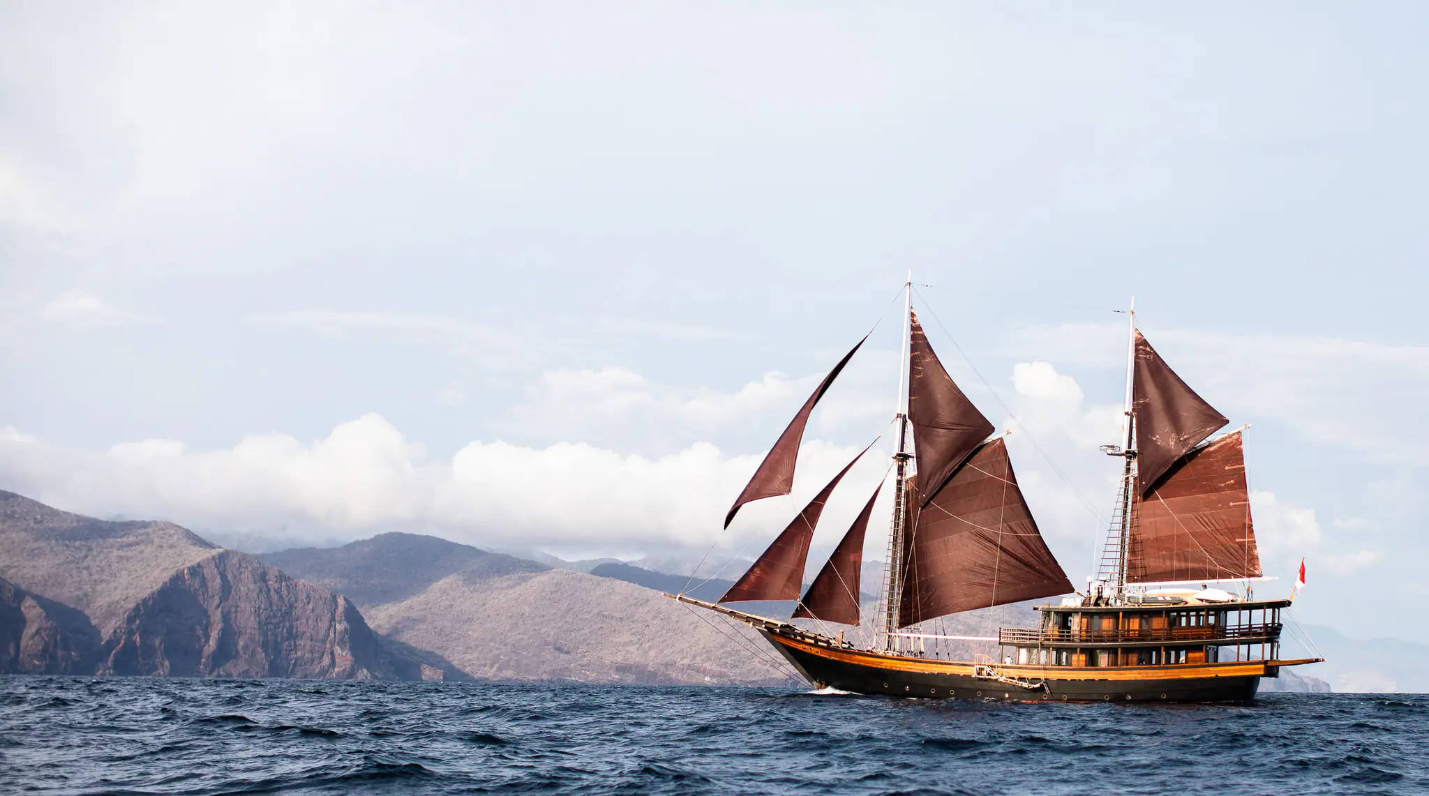 Dunia Baru Elegant Sailing Yacht | Sailing beside Komodo landscapes