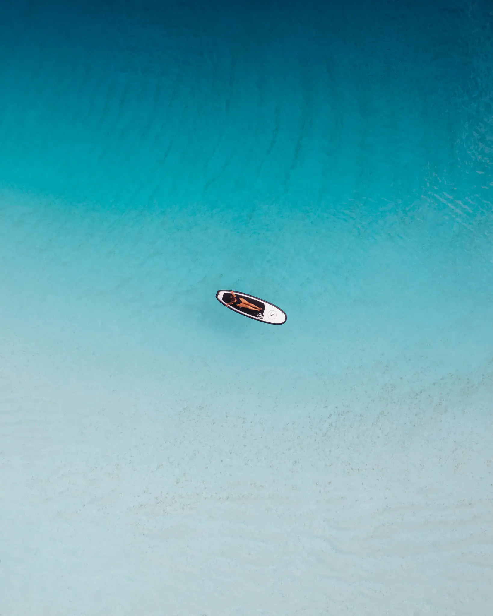 Mutiara Laut Luxury Yacht | Paddleboard floating on turquoise waters