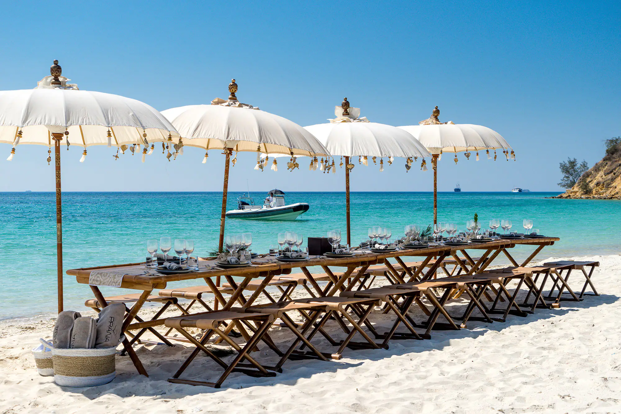 Prana Luxury Sailing Yacht | Beach dining setup with parasols