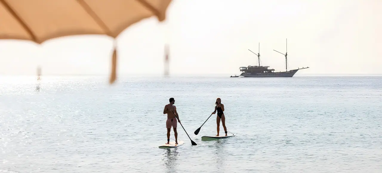 Prana Luxury Sailing Yacht | Paddleboarding in calm tropical waters
