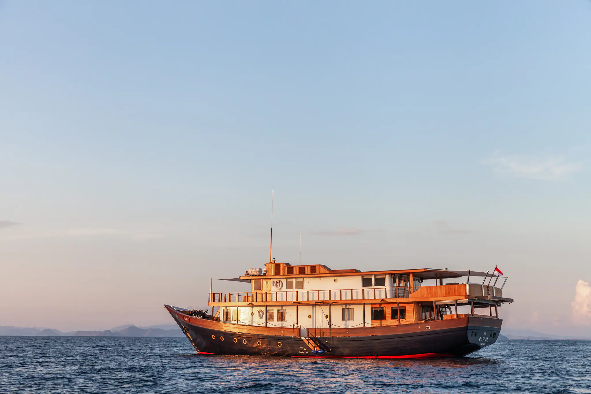Rebel Adventure Yacht | Cruising at sunset on calm waters