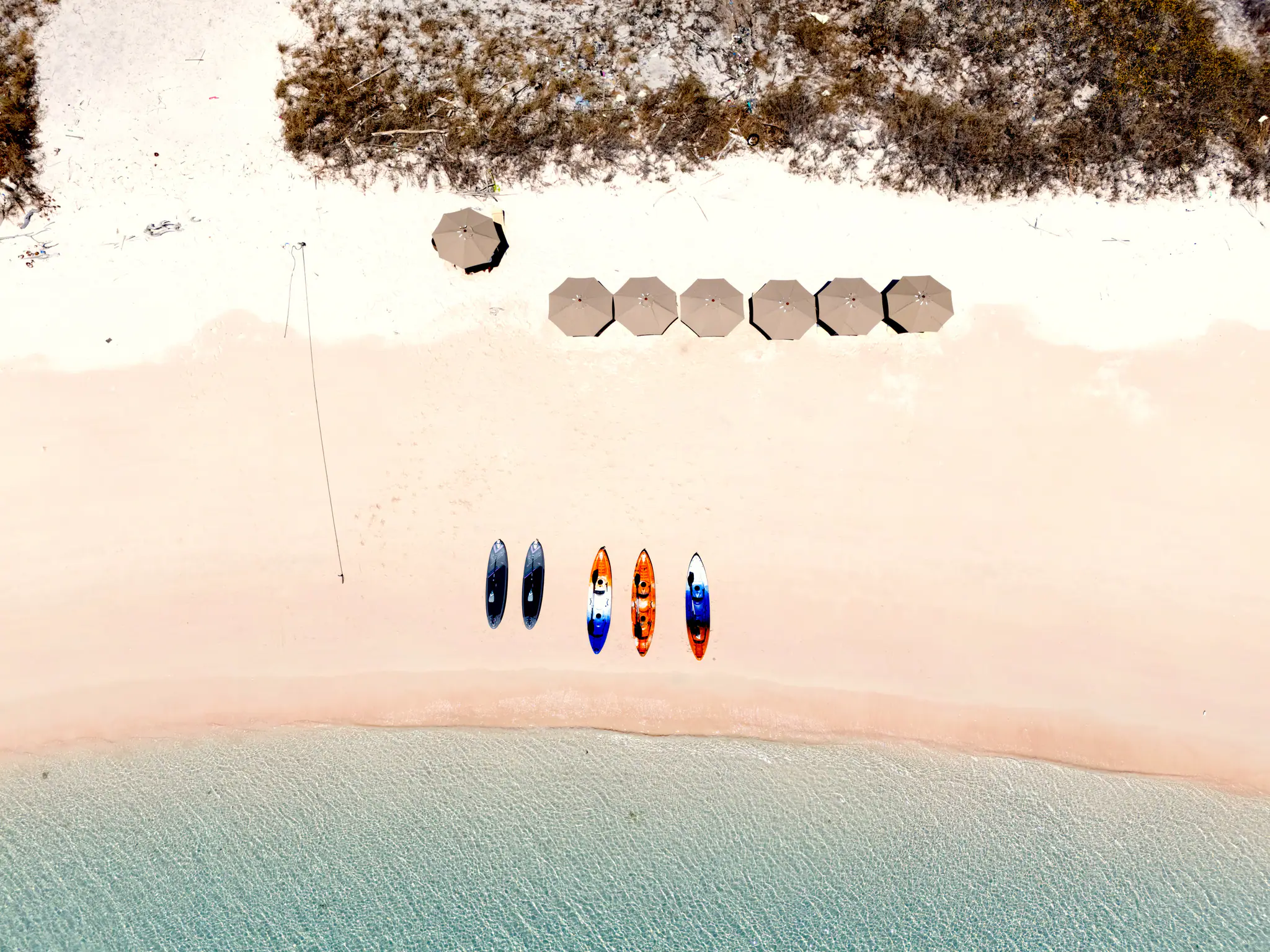 Sanctuary Grand Phinisi Yacht | Aerial tropical beach and paddleboards
