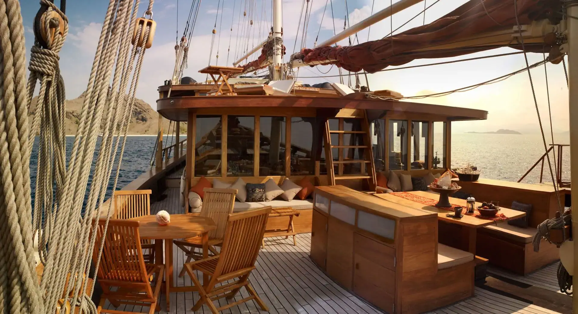 Si Datu Bua Traditional Sailing Yacht | Open deck lounge at sunrise