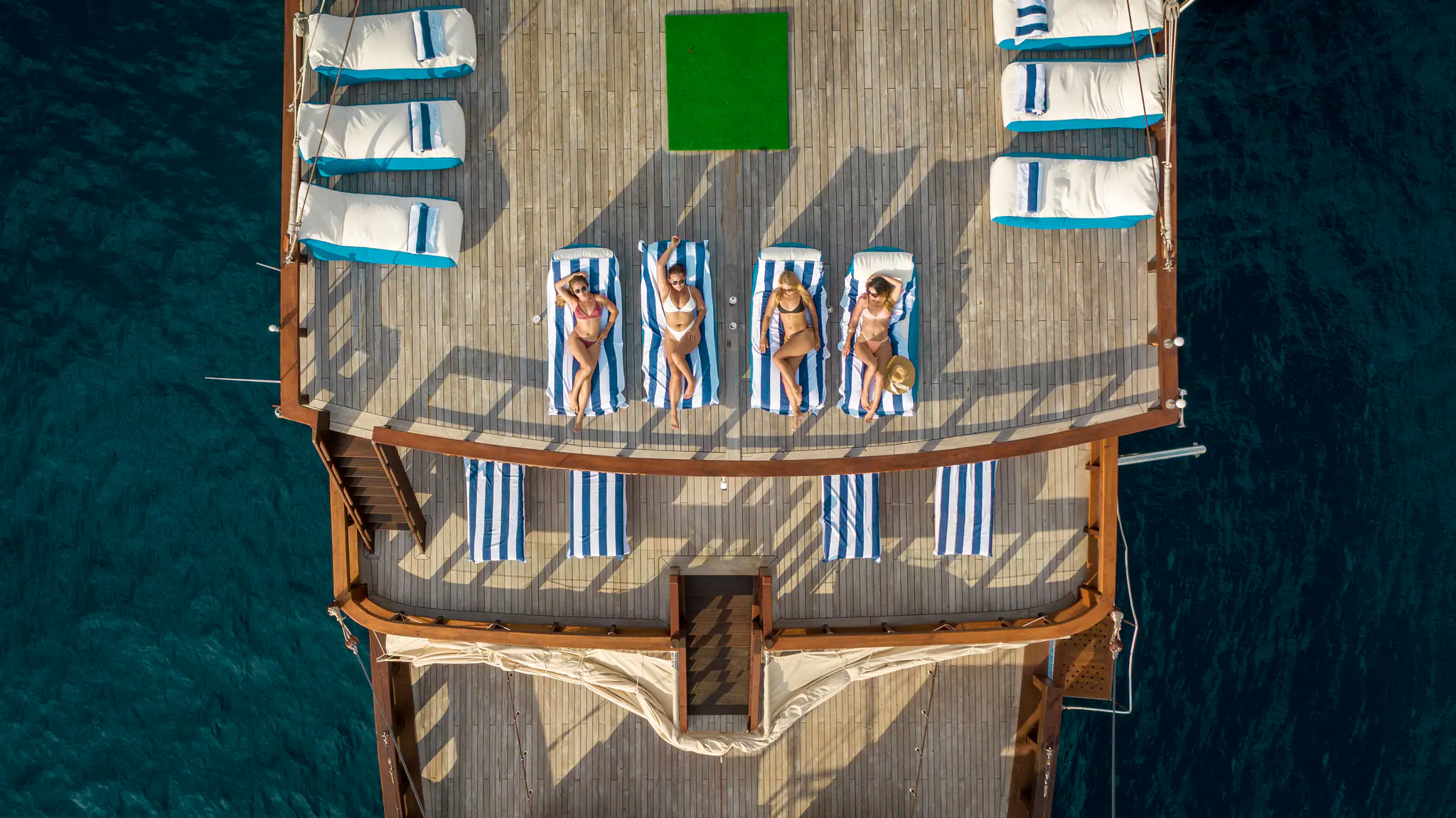 The Maj Oceanic Contemporary Phinisi Yacht | Aerial rooftop sun loungers