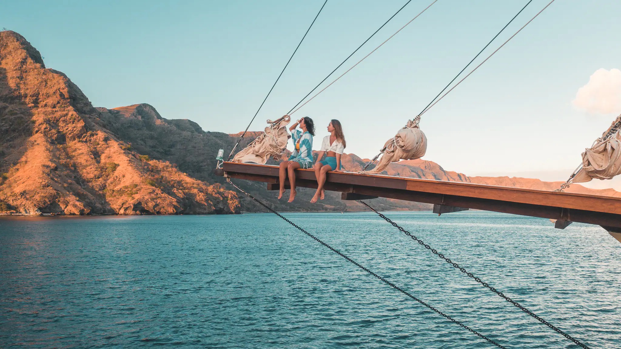 The Maj Oceanic Contemporary Phinisi Yacht | Guests relaxing on bowsprit net