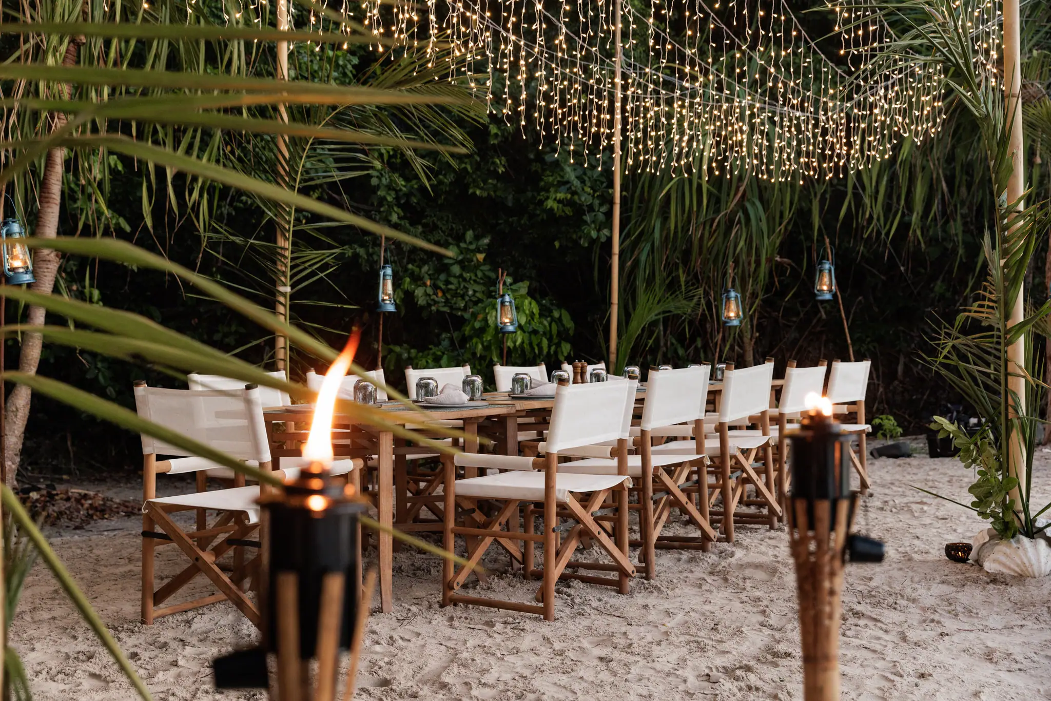 Vela Luxury Phinisi Yacht | Beach dinner beneath palm trees
