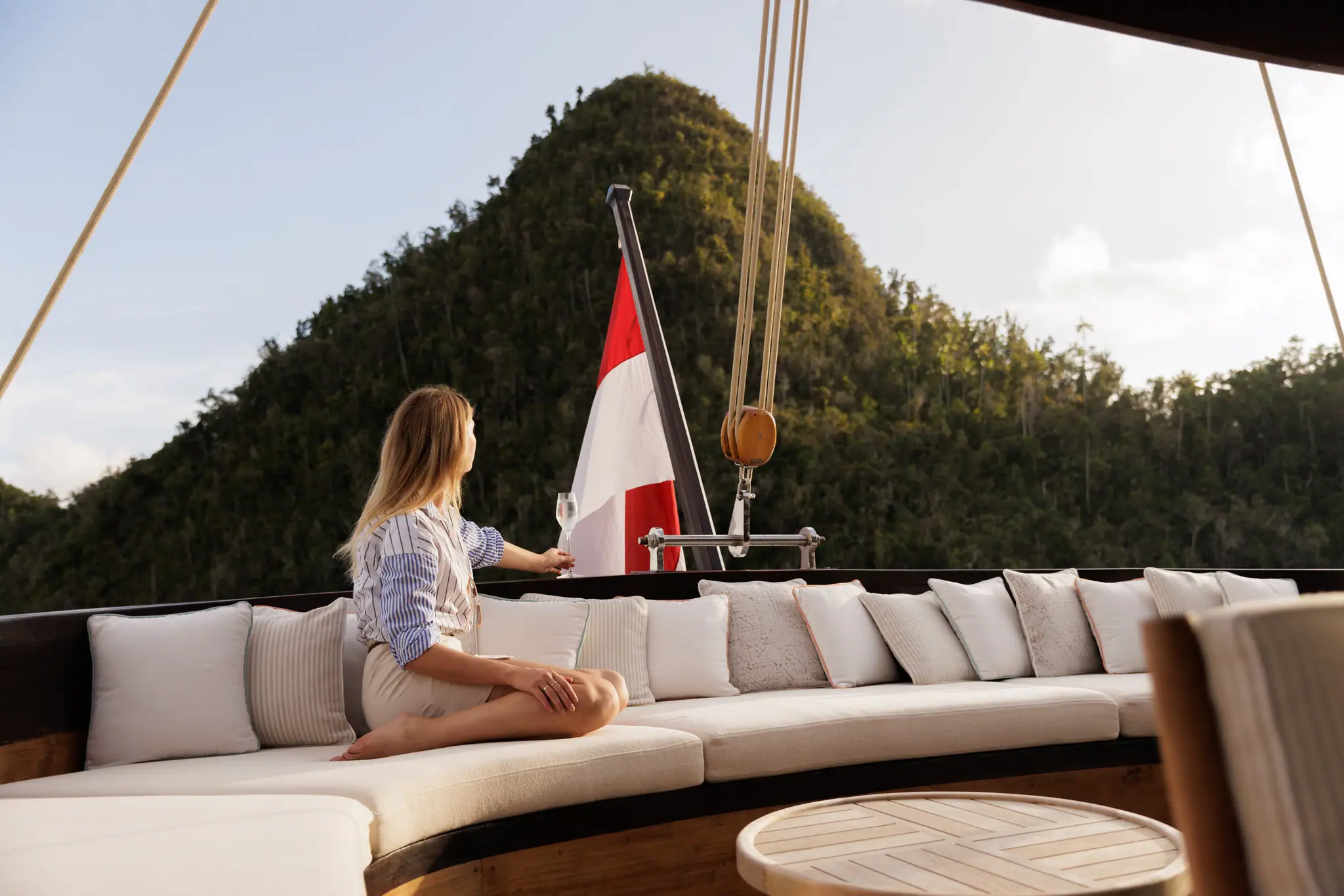 Vela Luxury Phinisi Yacht | Guest relaxing on aft deck