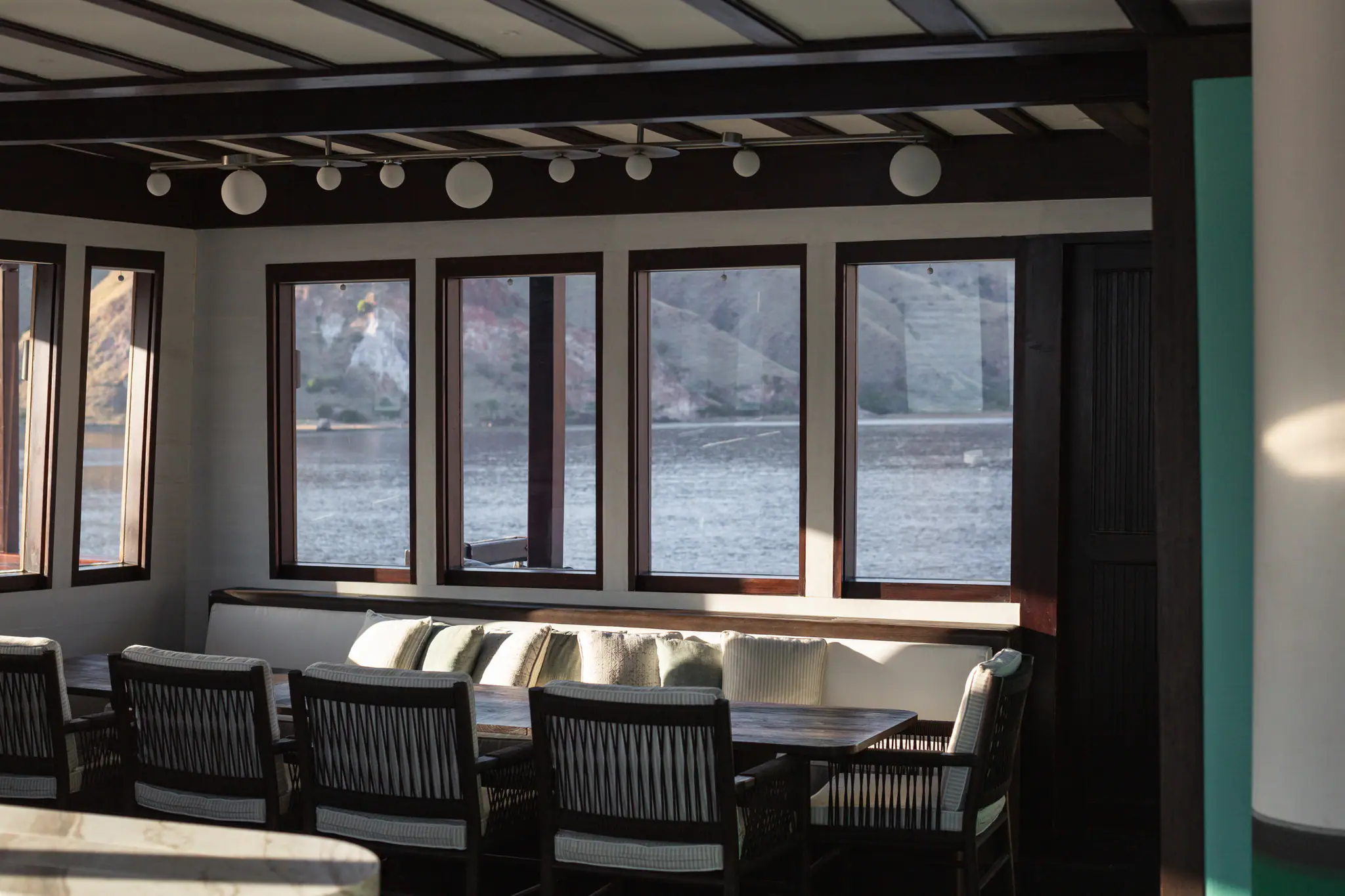 Vela Luxury Phinisi Yacht | Indoor dining room with sea views